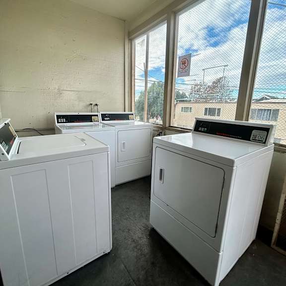 a room with two washing machines and a window.