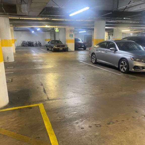 a grey car is parked in a parking garage.
