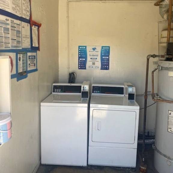 a white washing machine sits in a small room with a white wall and a red border.