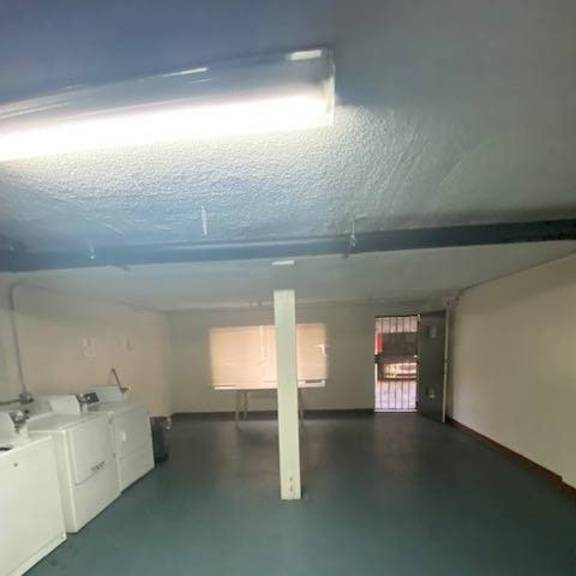 a room with a white sink and a green floor.