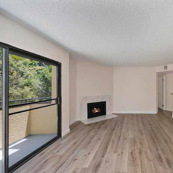 a living room with a fireplace and hardwood floors at croft plaza apartments, california