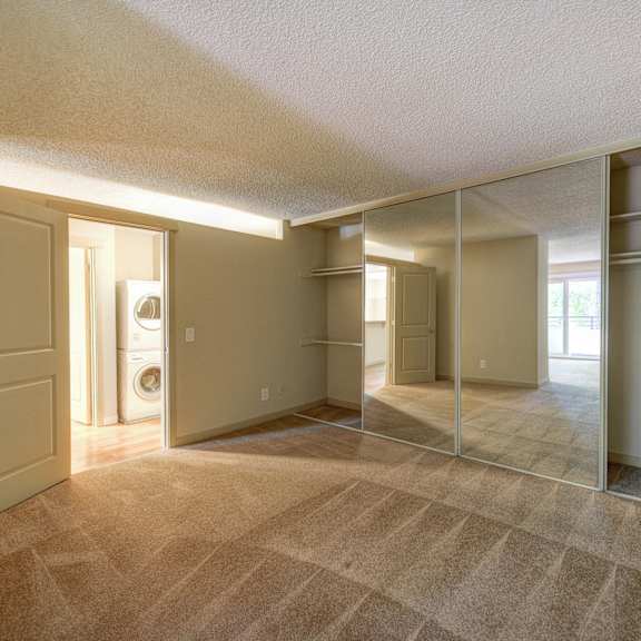 bedroom with view of in unit washer dryer at the retreat at walnut creek, walnut creek