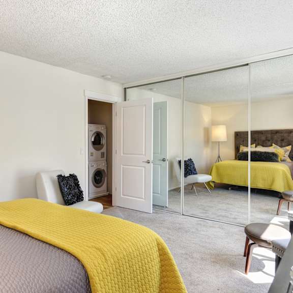 a bedroom with a bed and a mirrored closet doors at the retreat at walnut creek, walnut creek, california