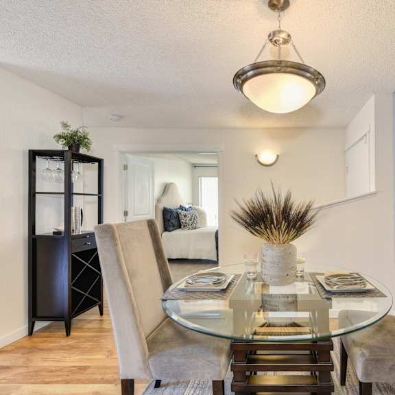 a dining room with a glass table and chairs at the retreat at walnut creek, walnut creek, california