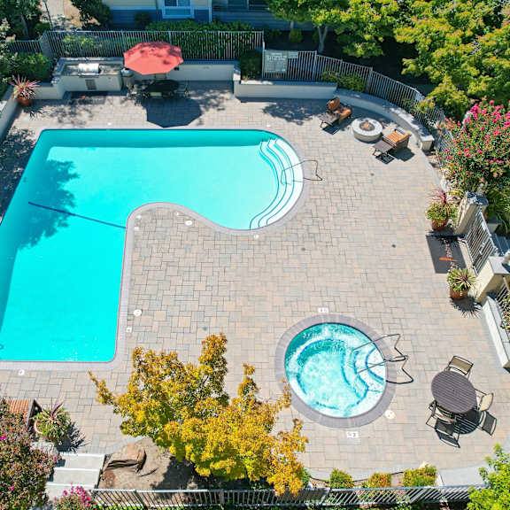 an aerial view of the retreat swimming pool and spa area with lounge options.