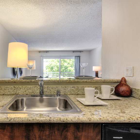 a kitchen with a sink and a window at the retreat at walnut creek, walnut creek, california