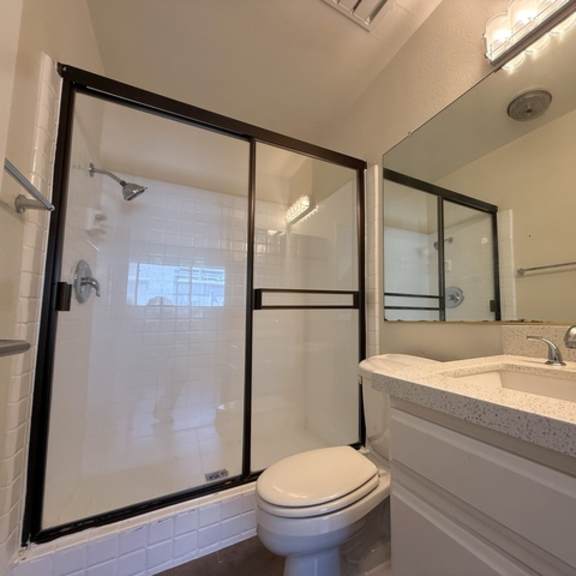 Thumbnail 6 of 17 A white toilet sits next to a sink in a bathroom.
