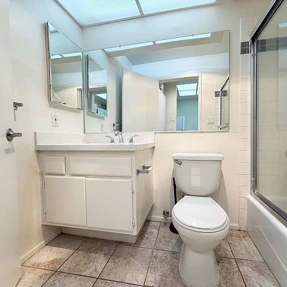 Thumbnail 4 of 39 A white toilet sits next to a sink in a bathroom.