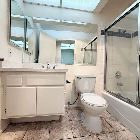 Thumbnail 10 of 39 A white toilet is in a bathroom with a walk-in shower.