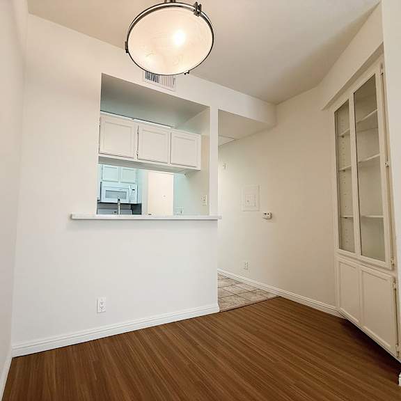 Thumbnail 18 of 39 A room with a window and a light fixture.