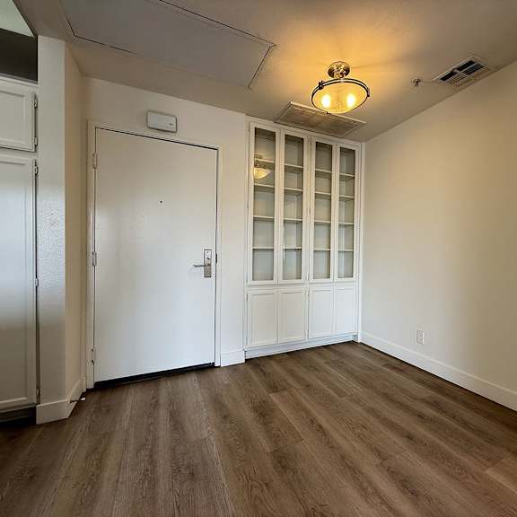 Thumbnail 13 of 29 A room with a white door and a window with white blinds.