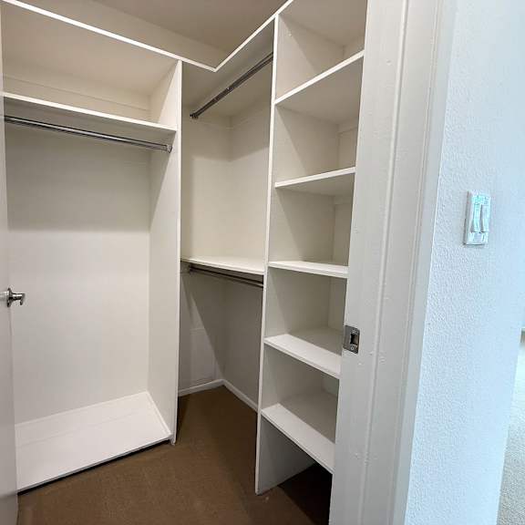 Thumbnail 15 of 29 A white closet with shelves and a door open.