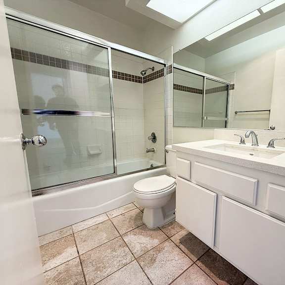 Thumbnail 11 of 53 A bathroom with a toilet, sink, and shower.
