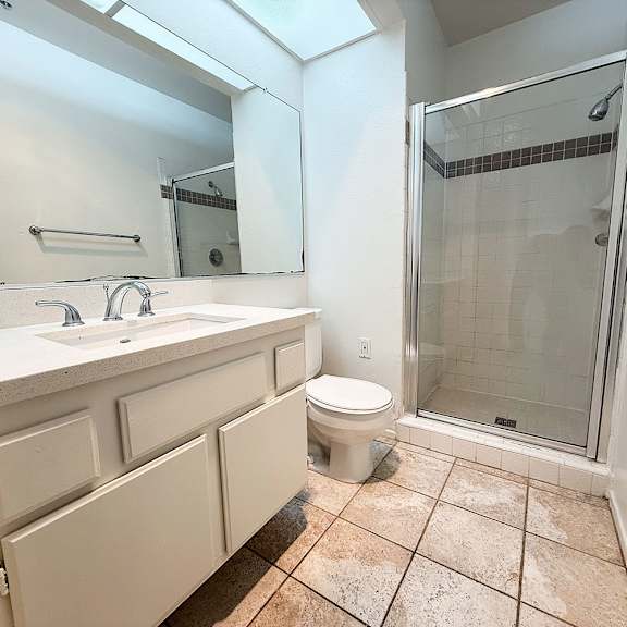 Thumbnail 19 of 53 A bathroom with a sink, toilet, and shower.