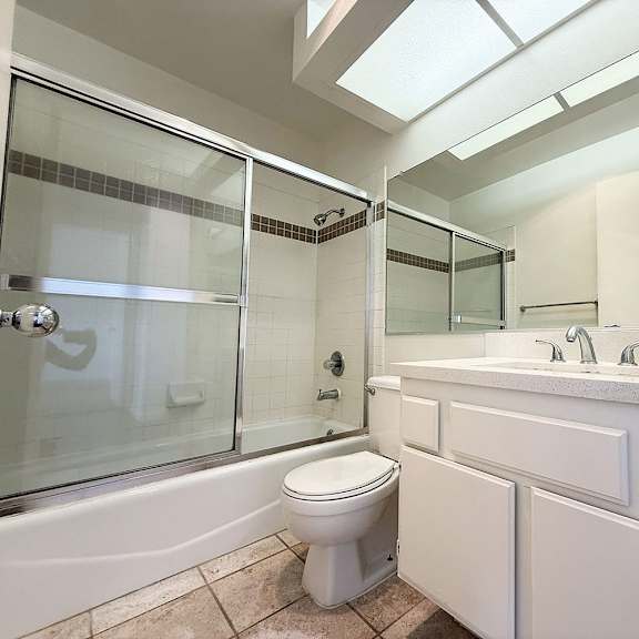 Thumbnail 8 of 53 A white bathroom with a toilet, sink, and shower.
