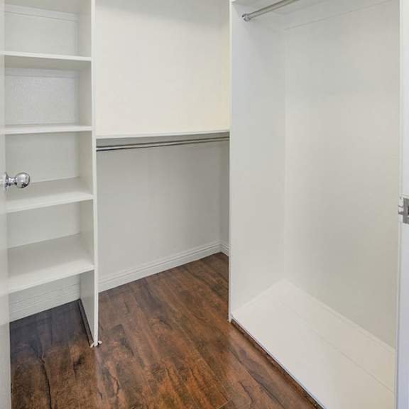 Thumbnail 39 of 39 A white closet with shelves and a door.