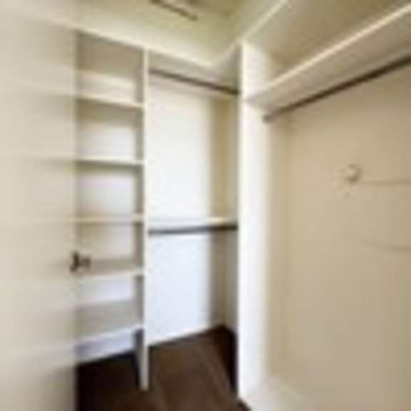 Thumbnail 51 of 53 A white closet with shelves and a door.