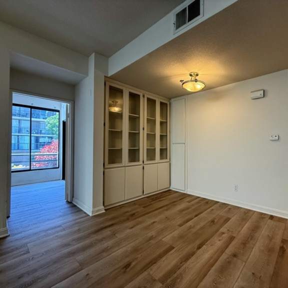 Thumbnail 6 of 26 A room with wooden floors and white walls.