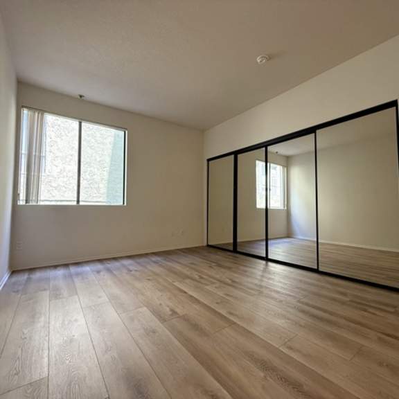 Thumbnail 14 of 26 A room with a sliding door and a window.