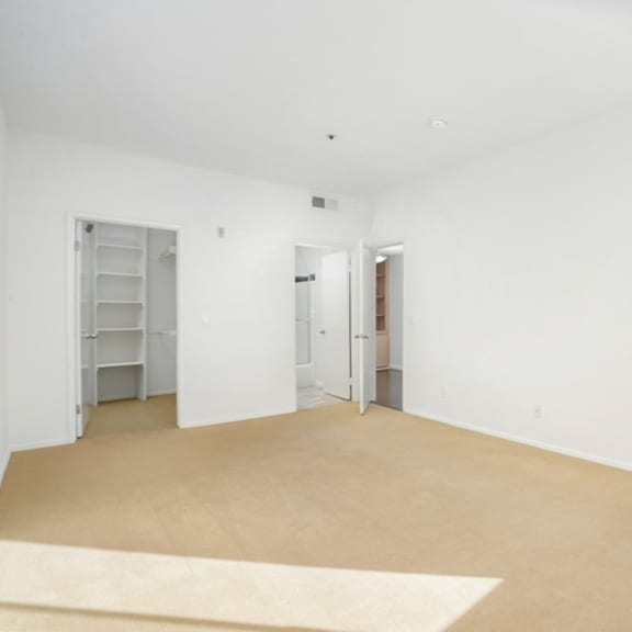 Thumbnail 10 of 17 Empty room with white walls and carpet.