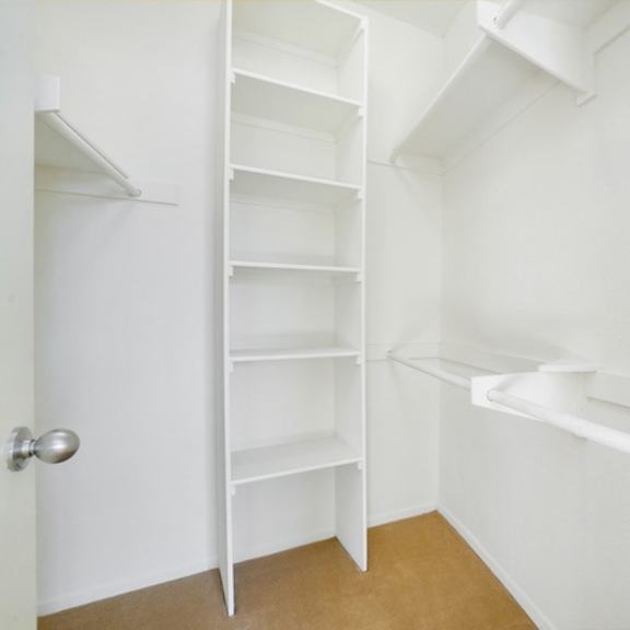 Thumbnail 15 of 17 A white closet with shelves and a door.
