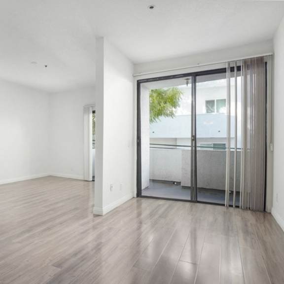 Thumbnail 9 of 11 A room with a fireplace and sliding glass doors.