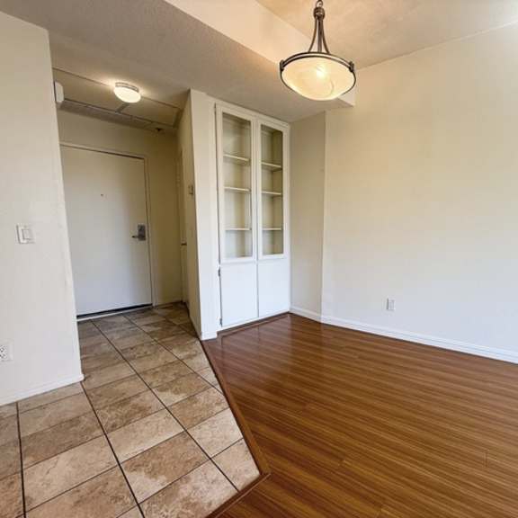 Thumbnail 4 of 18 A room with a wooden floor and a white door.