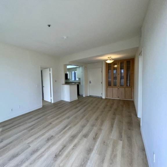 Thumbnail 4 of 27 A room with a fireplace and wood flooring.