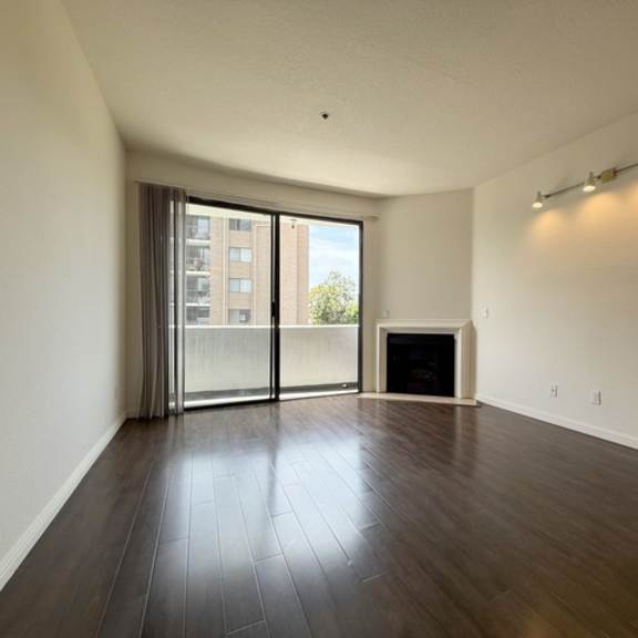 Thumbnail 17 of 27 A room with a fireplace and sliding glass doors.