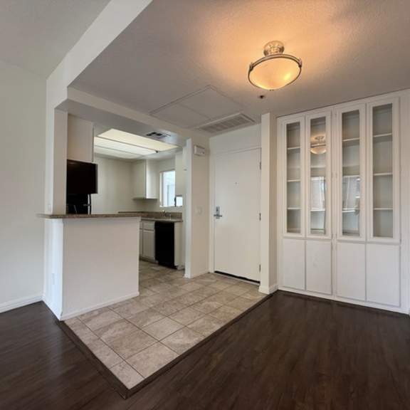 Thumbnail 18 of 27 A room with a white counter and a white fridge.