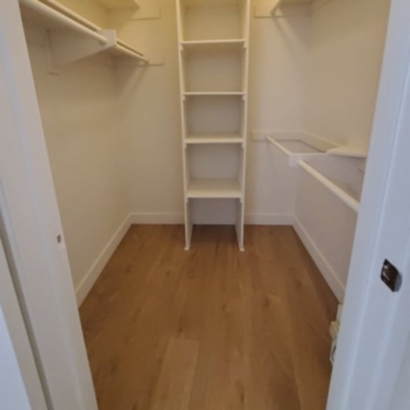 Thumbnail 9 of 9 A small white closet with a ladder.