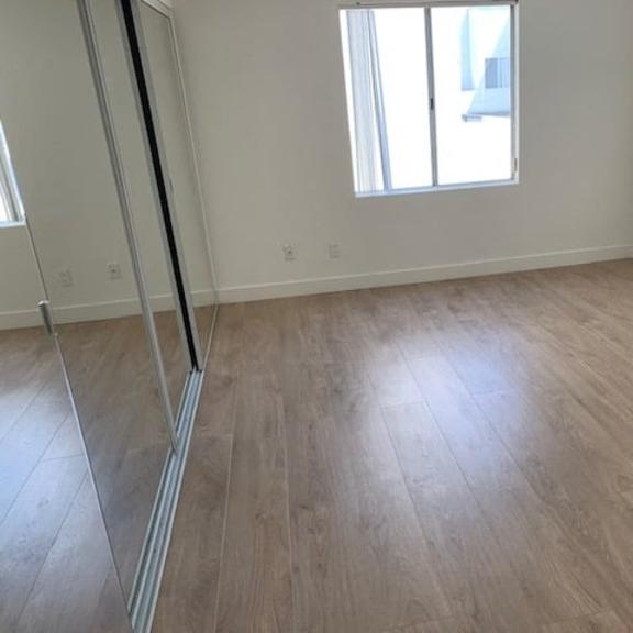 Thumbnail 16 of 16 A room with wooden flooring and a window.