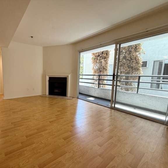 Thumbnail 6 of 53 A living room with a fireplace and sliding glass doors.