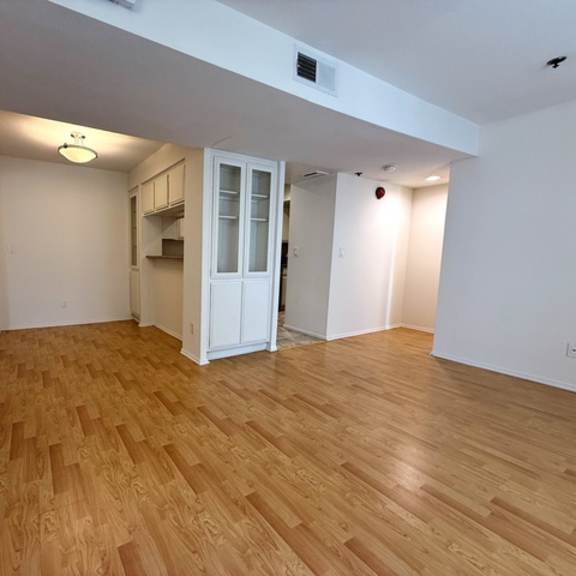 Thumbnail 5 of 53 A room with wooden flooring and a white door.