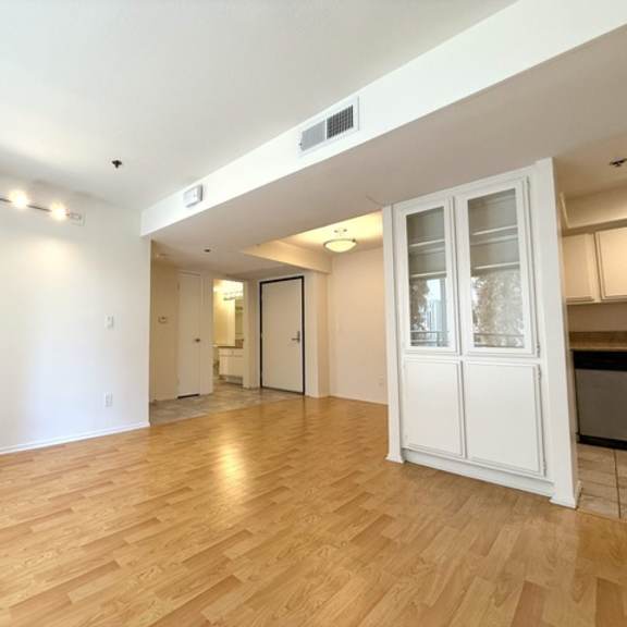 Thumbnail 19 of 53 A room with wooden flooring and white walls.