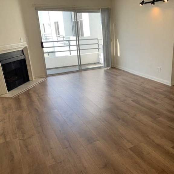 Thumbnail 18 of 18 A room with a fireplace and sliding glass doors.