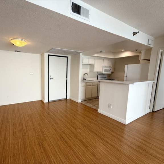 Thumbnail 5 of 24 A room with wooden floors and white walls.