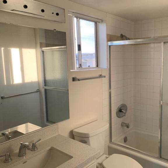 Thumbnail 9 of 13 A bathroom with a sink, toilet, and bathtub.