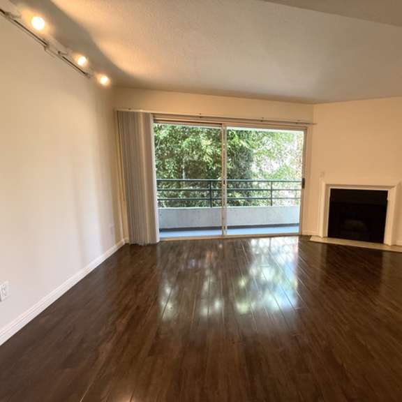 Thumbnail 17 of 28 A room with a fireplace and sliding glass doors.