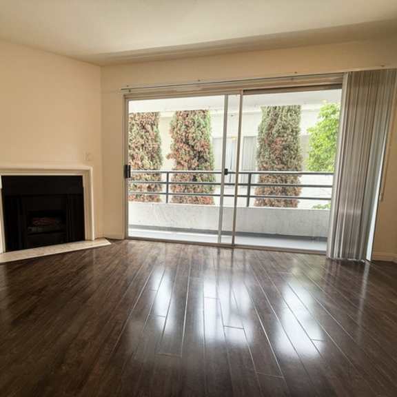 Thumbnail 16 of 53 A room with a fireplace and sliding glass doors.