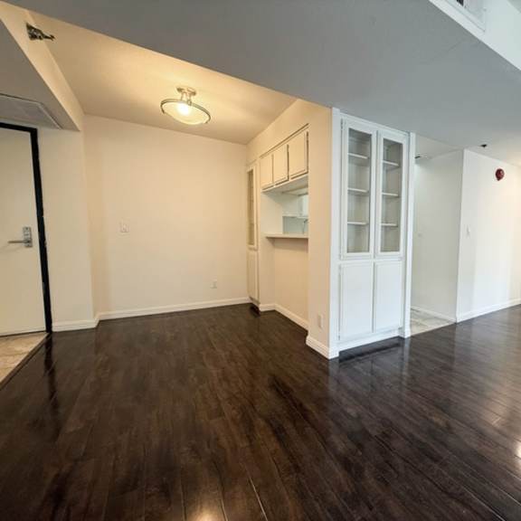 Thumbnail 29 of 53 A room with wooden floors and white walls.