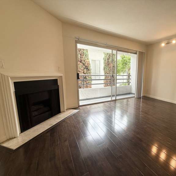 Thumbnail 30 of 53 A room with a fireplace and sliding glass doors.