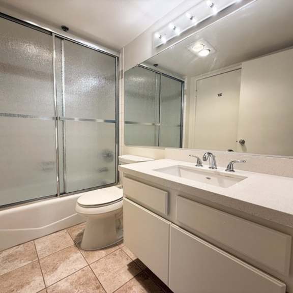 Thumbnail 39 of 53 A bathroom with a toilet, sink, and shower.