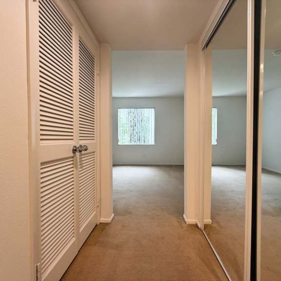 Thumbnail 35 of 53 A room with a white door and a window.