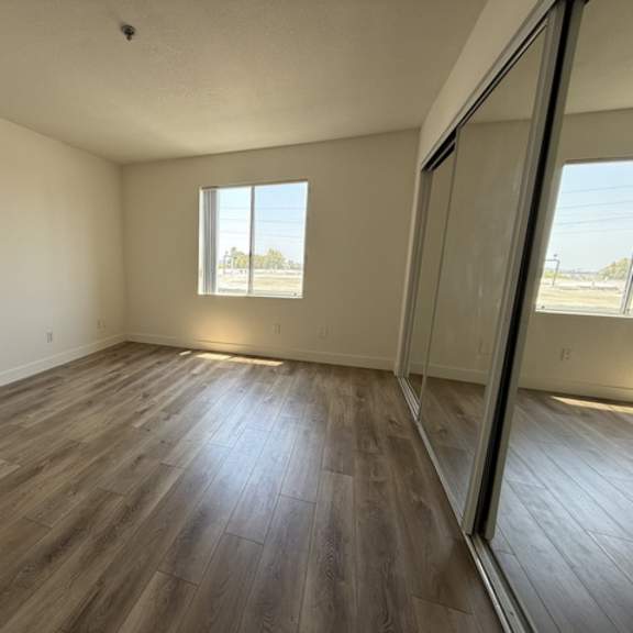 Thumbnail 5 of 13 A room with wooden flooring and a window.