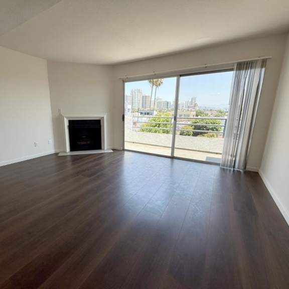 Thumbnail 21 of 31 A room with a fireplace and sliding glass doors.