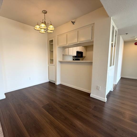 Thumbnail 27 of 31 A room with wooden floors and white walls.