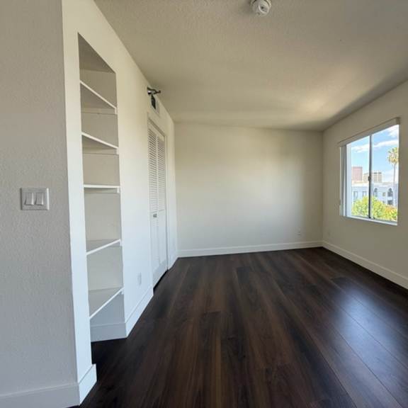 Thumbnail 23 of 28 A room with wooden floors and white walls.