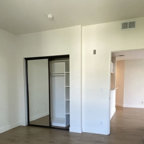 Thumbnail 17 of 54 A room with a sliding door and a wooden floor.