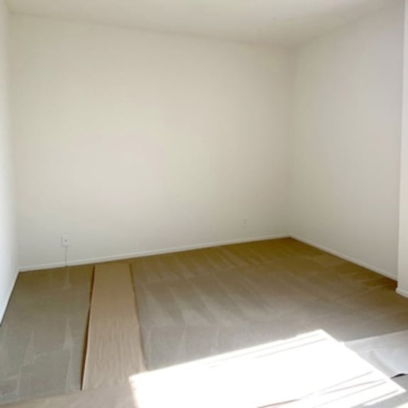 Thumbnail 22 of 22 A room with wooden flooring and white walls.